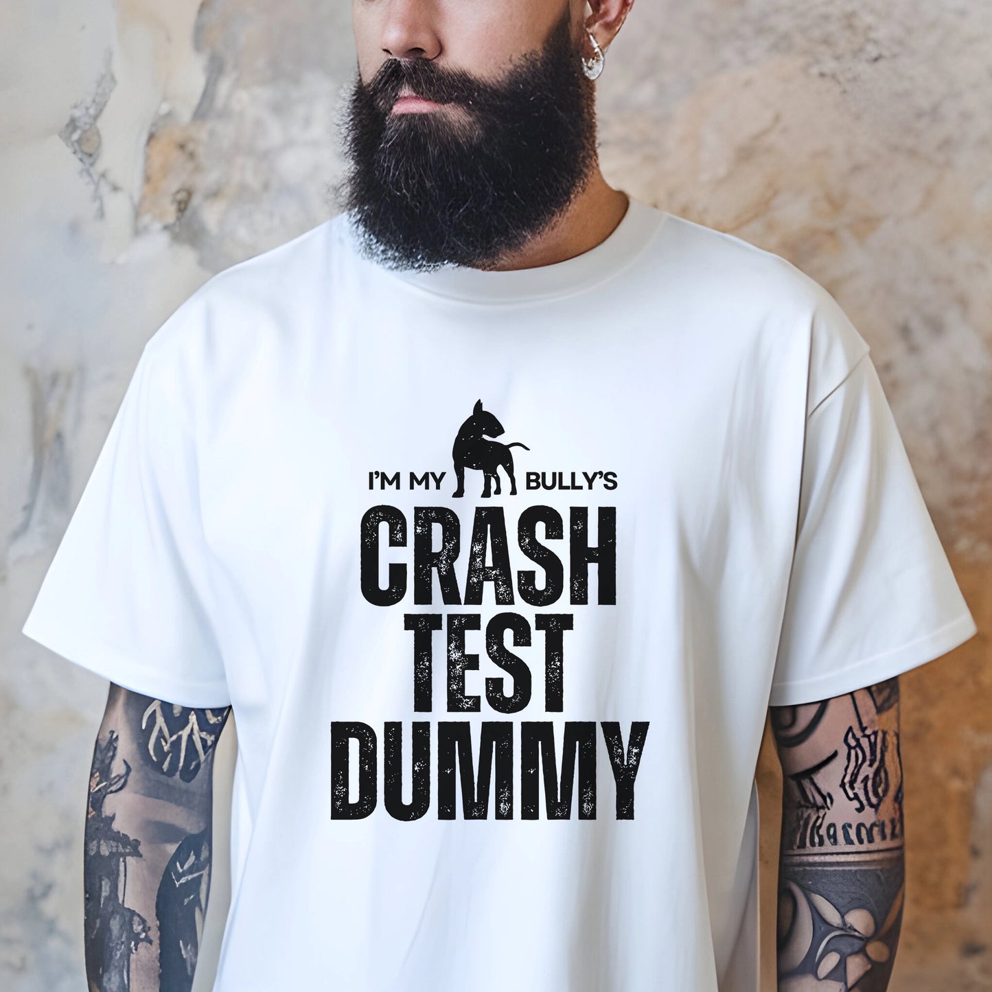 Person wearing a white t-shirt with 'I'm my bully's crash test dummy' text and graphic.