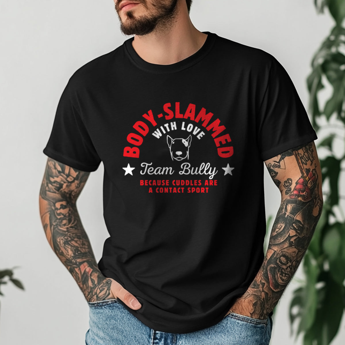 Man wearing a black t-shirt with a graphic design and text 'body-slammed with love'