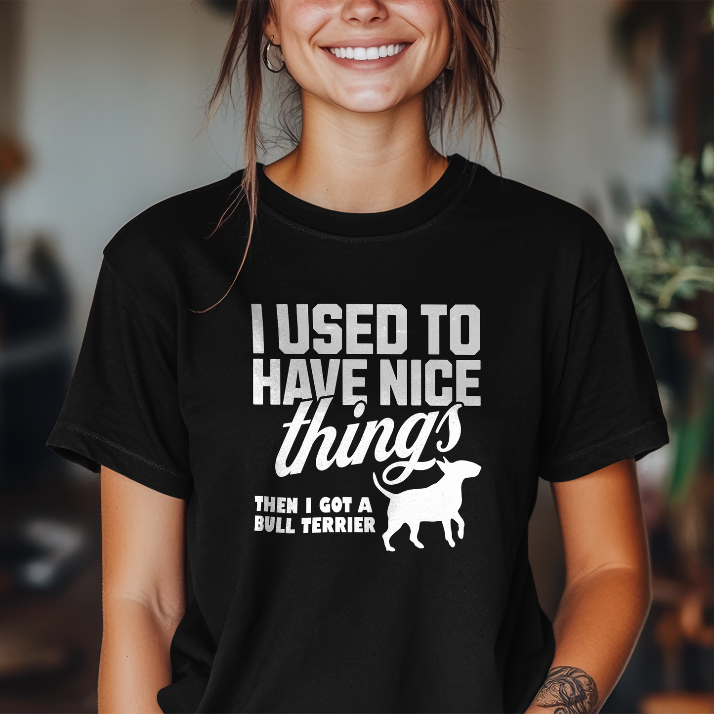 Person wearing a black t-shirt with a humorous text design about a Bull Terrier, "I used to have nice things, then i got a Bull Terrier".