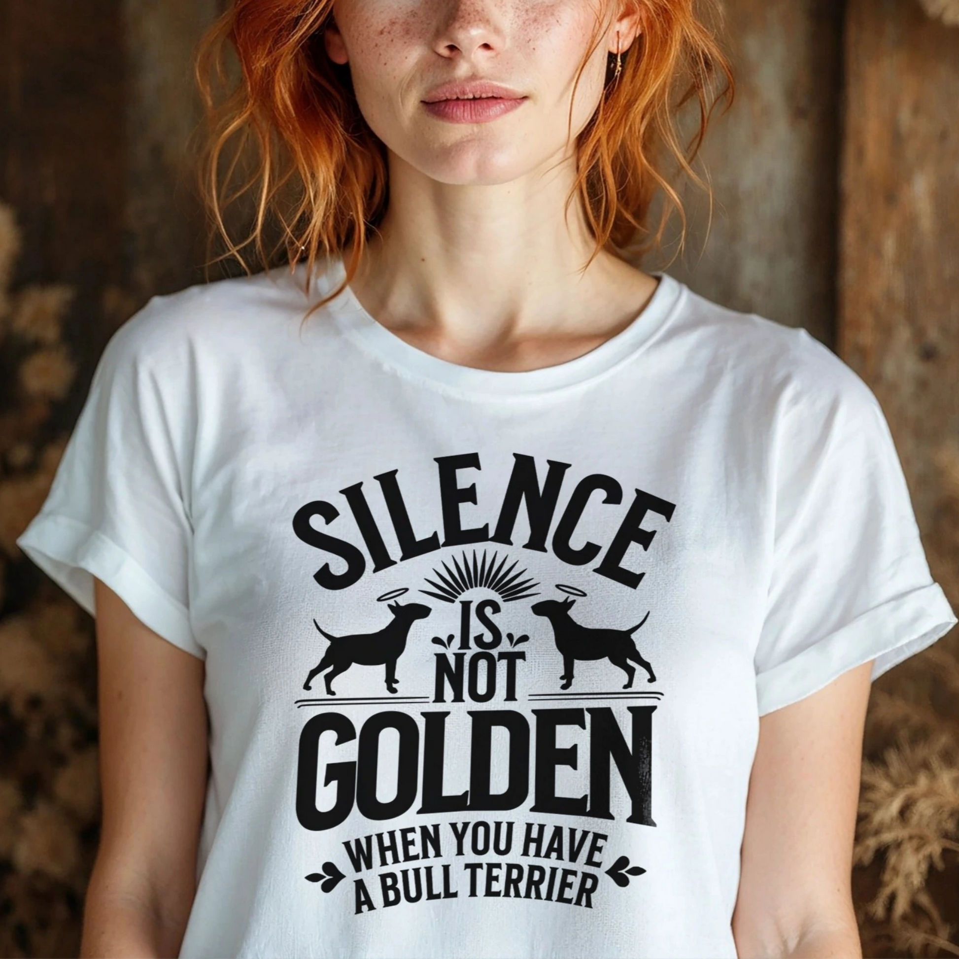 Woman wearing a white t-shirt with a black graphic and text reading "Silence is not golden when you have a bull terrier."