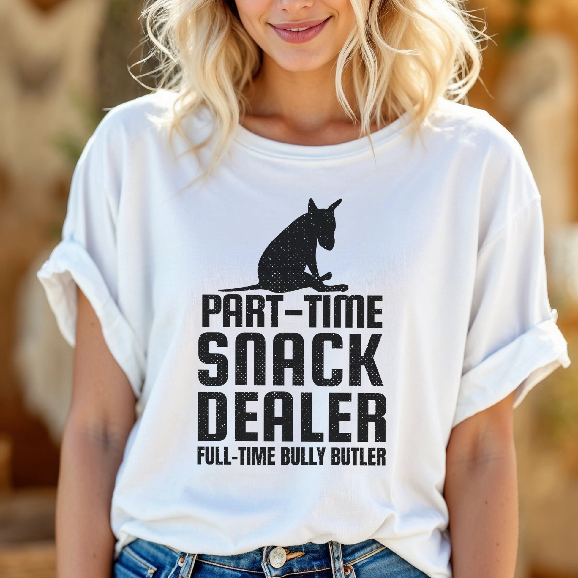 Person wearing a white t-shirt with black graphic of a bull terrier sitting and words reading "Part-time Snack Dealer, Full-time Bully Butler".