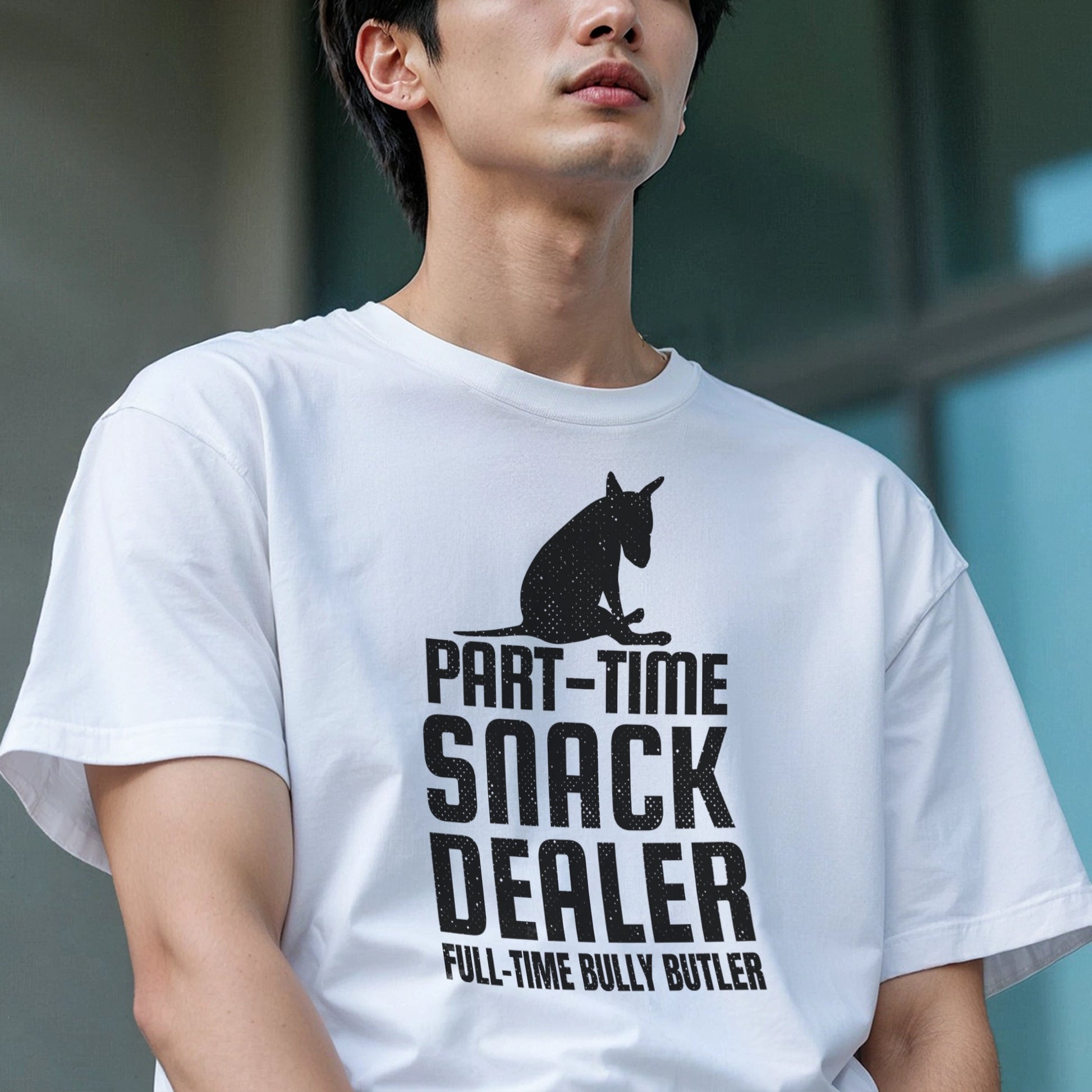Person wearing a white t-shirt with black graphic of a bull terrier sitting and words reading "Part-time Snack Dealer, Full-time Bully Butler".