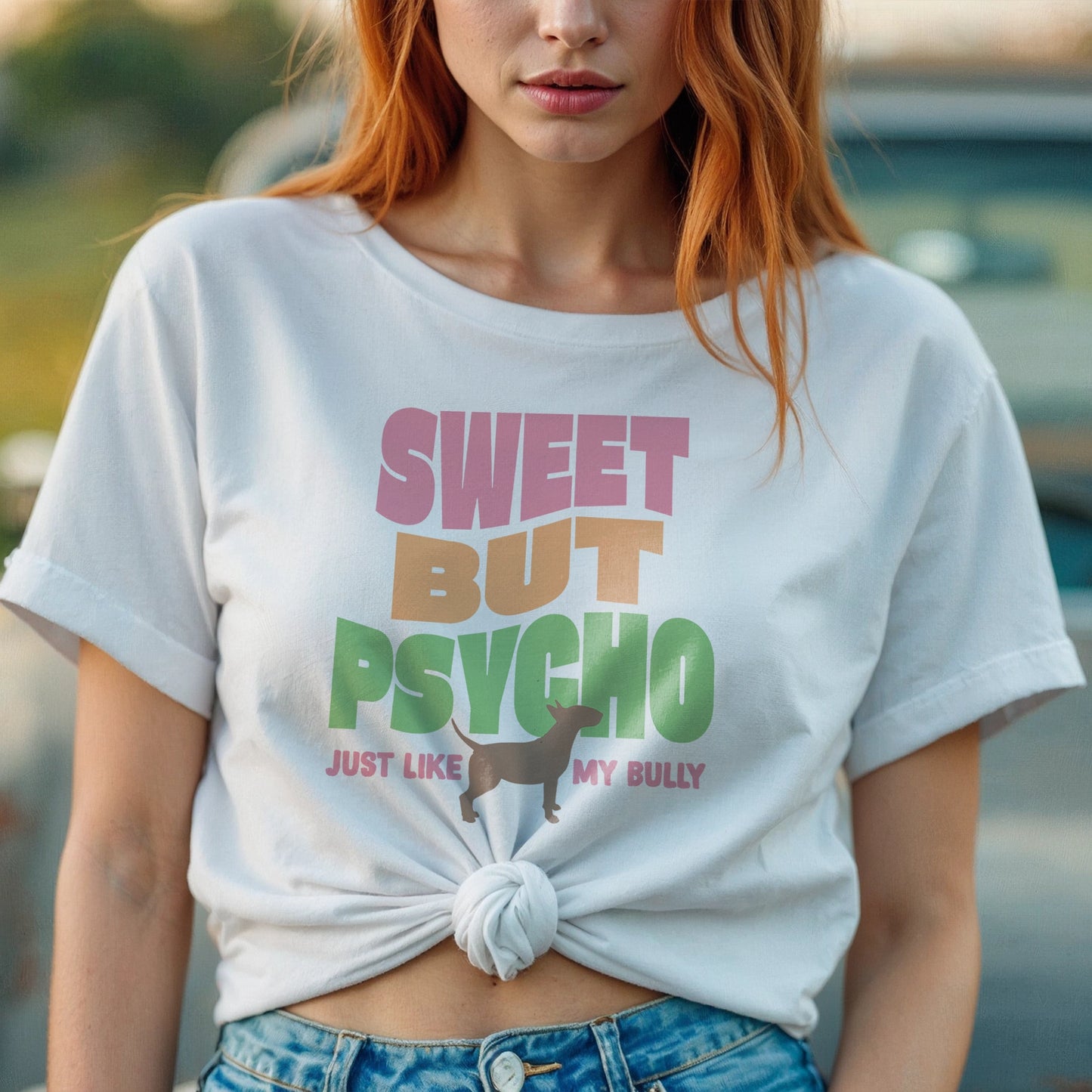 Person wearing a white t-shirt with colorful text reading "sweet but psycho just like my bully", with graphic of bull terrier.