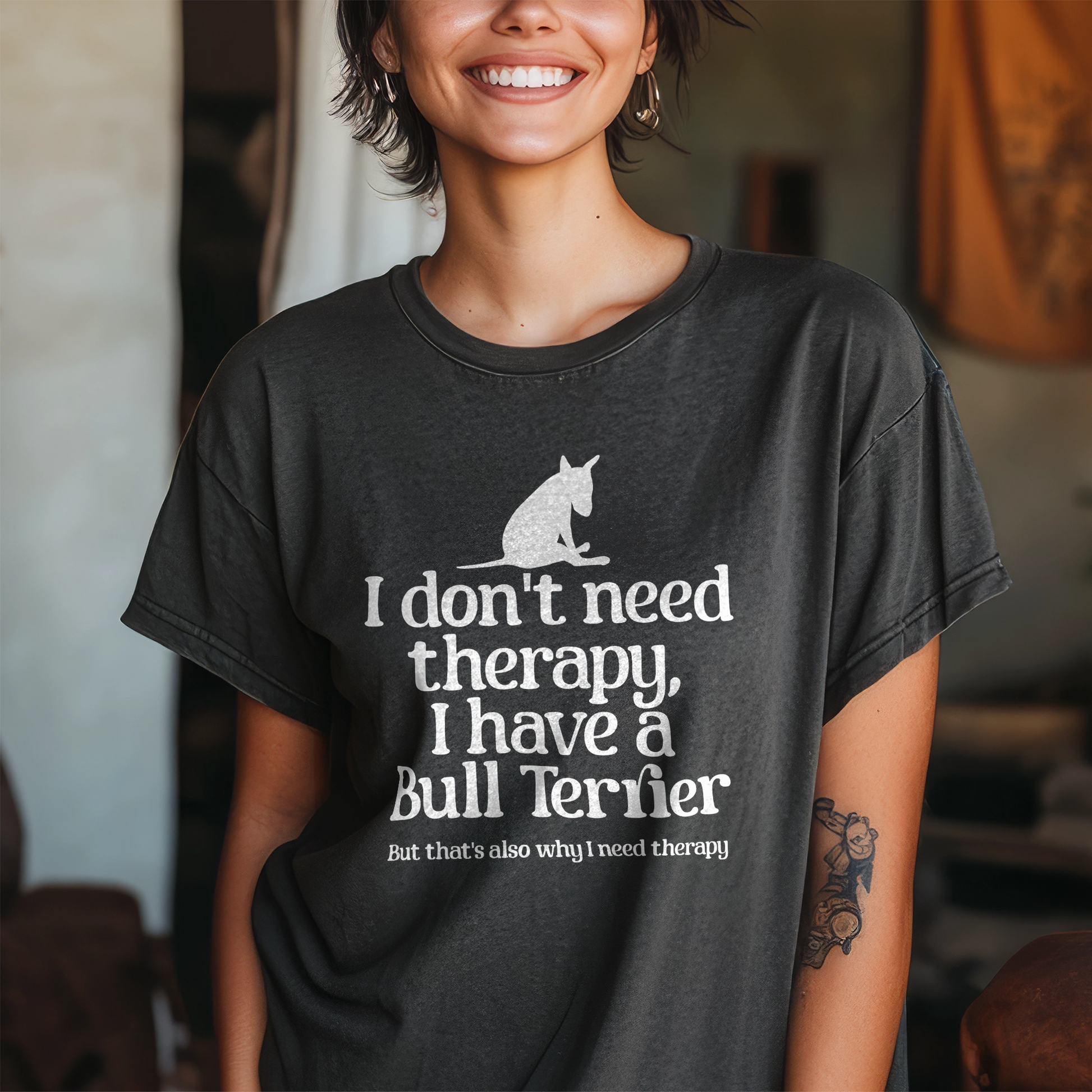 Person wearing a black t-shirt with a dog graphic and text 'I don't need therapy, I have a Bull Terrier. But that's also why i need therapy".