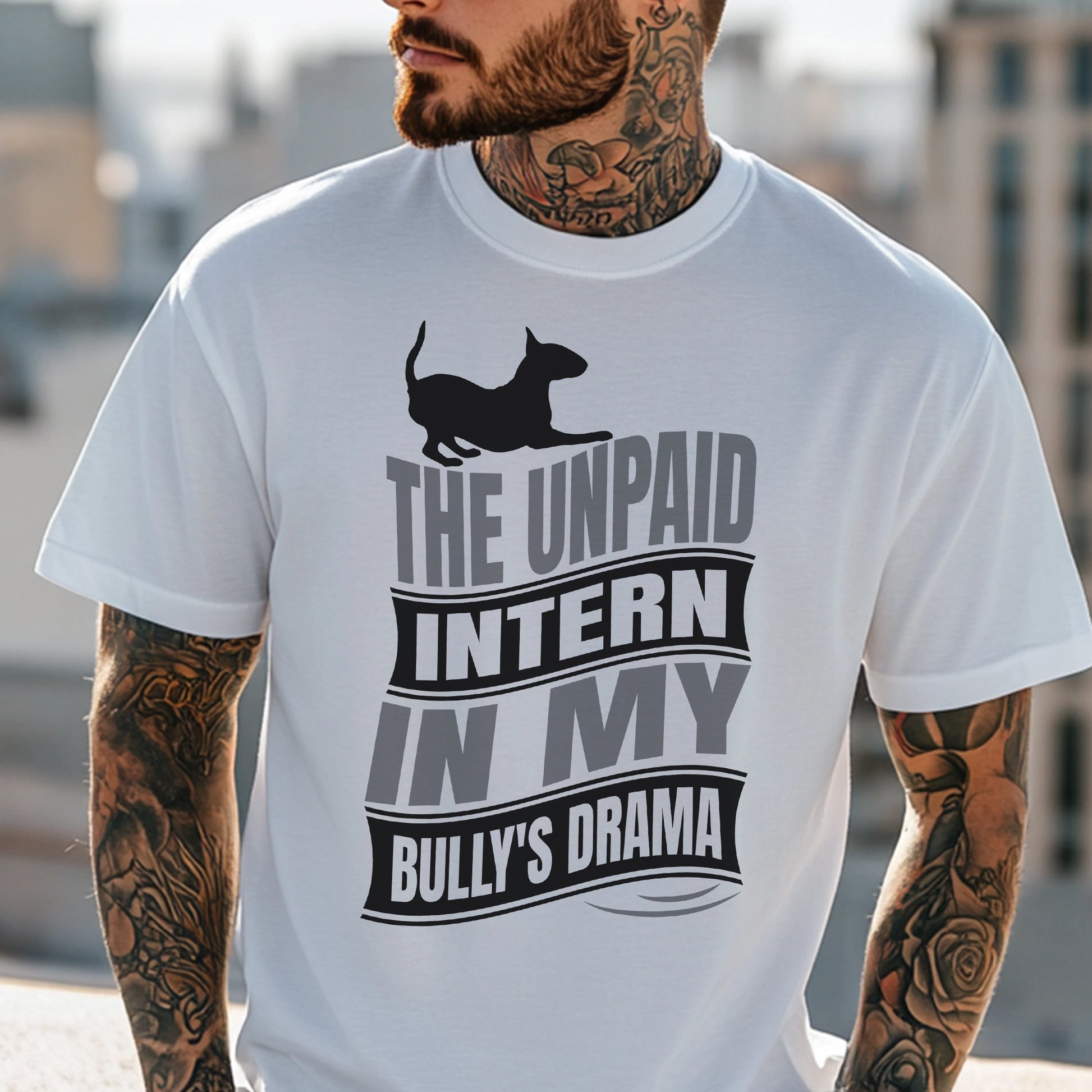 Man wearing a white t-shirt with a graphic text reading "The unpaid intern in my bully's drama", with a graphic of a playful bull terrier. 