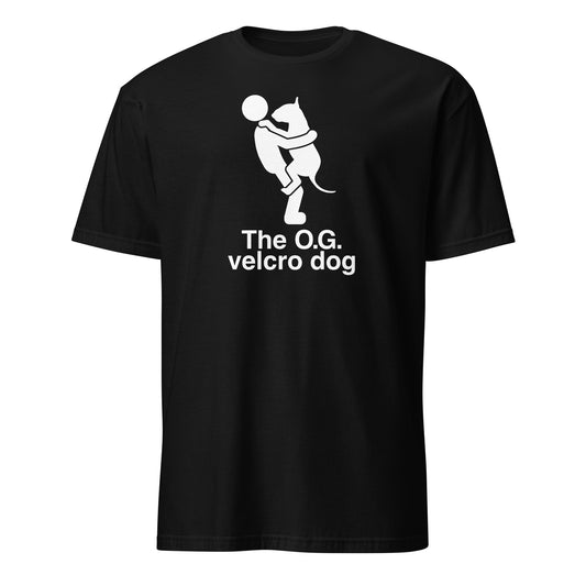 Product mockup of a black t-shirt with a graphic of a bull terrier jumping into a persons arms, and text 'The O.G. velcro dog'.