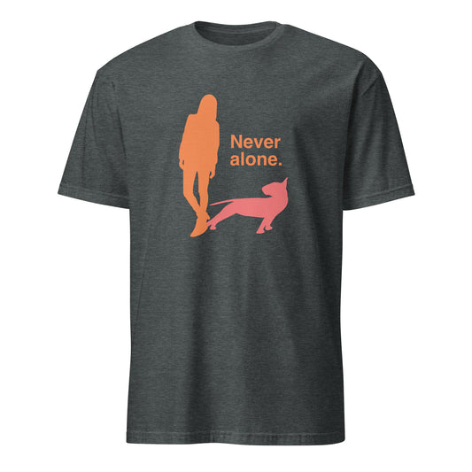 Product mockup of a dark grey t-shirt with a graphic of an orange figure and coral bull terrier shadow, and the text 'Never alone.' 