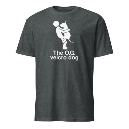 Product mockup of a dark grey t-shirt with a graphic of a bull terrier jumping into a persons arms, and text 'The O.G. velcro dog'.