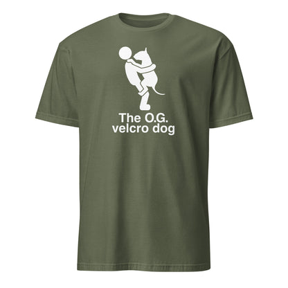 Product mockup of a military green t-shirt with a graphic of a bull terrier jumping into a persons arms, and text 'The O.G. velcro dog'.