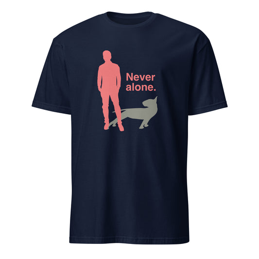 Product mockup of a navy t-shirt with a graphic of a red figure and grey bull terrier shadow, and the text 'Never alone.' on a city street.
