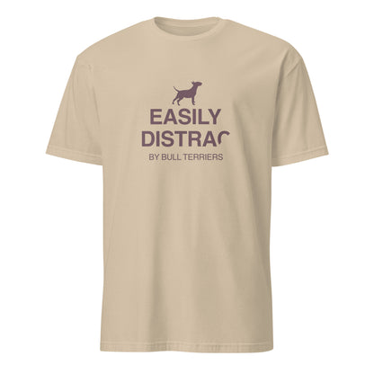 Product mockup - sand t-shirt with text and a dog graphic reading EASILY DISTRACTED BY BULL TERRIERS
