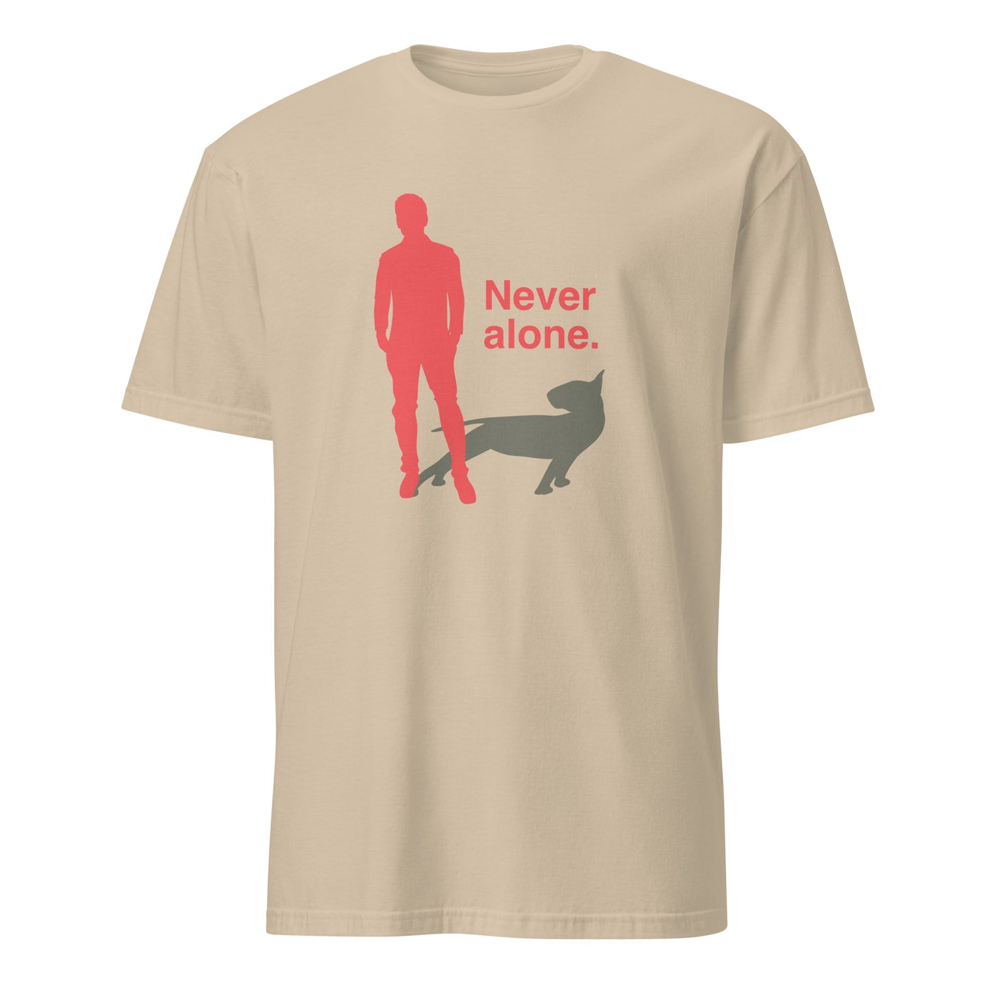 Product mockup of a sand t-shirt with a graphic of a red figure and grey bull terrier shadow, and the text 'Never alone.' on a city street.