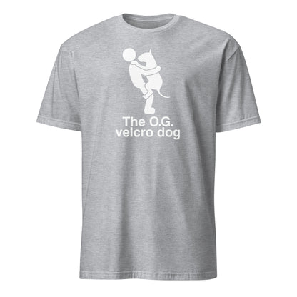 Product mockup of a grey t-shirt with a graphic of a bull terrier jumping into a persons arms, and text 'The O.G. velcro dog'.
