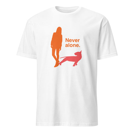 Product mockup of a white t-shirt with a graphic of an orange figure and coral bull terrier shadow, and the text 'Never alone.' 